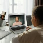 Child attending an online lesson at home via laptop. Remote education.